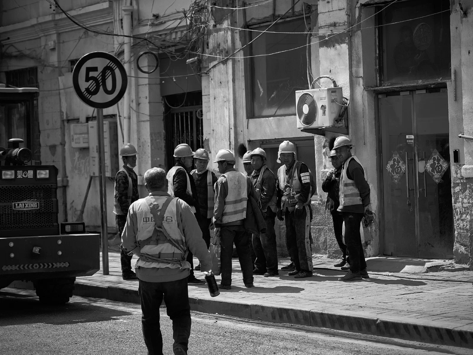 People and intersecting figures in the street