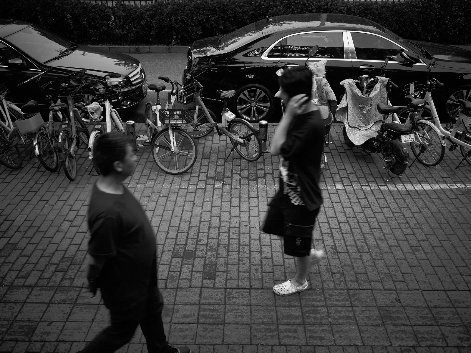 People and intersecting figures in the street