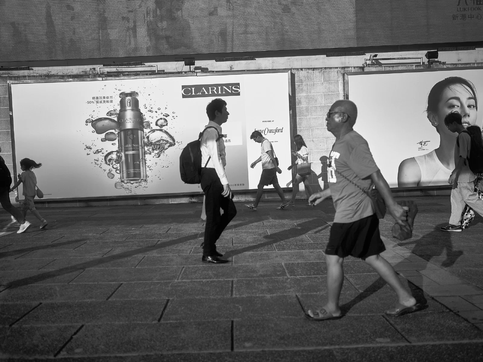 People and intersecting figures in the street