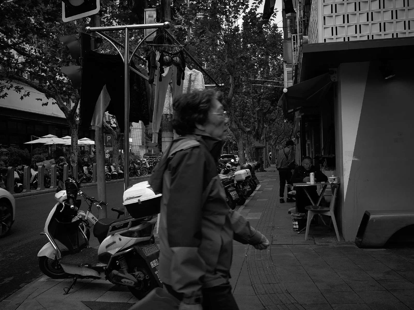 People and intersecting figures in the street