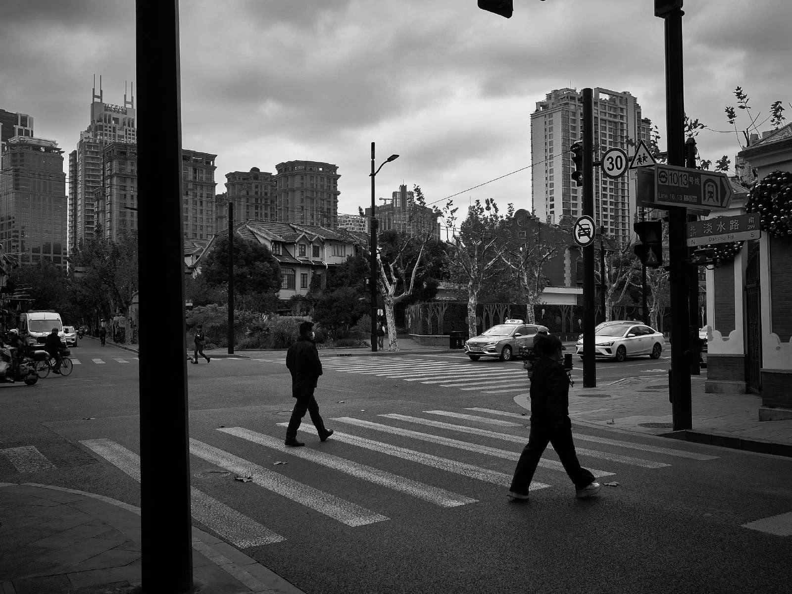 People and intersecting figures in the street