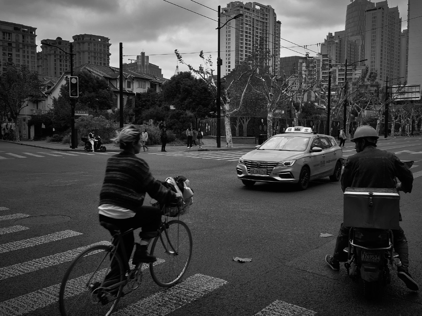 People and intersecting figures in the street