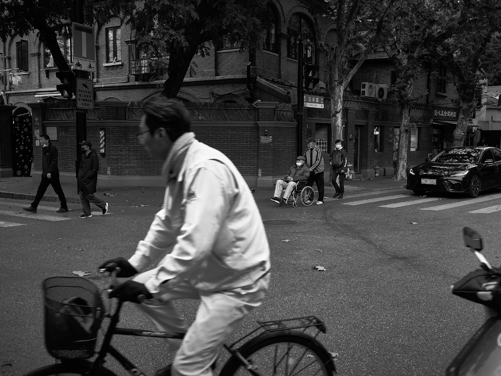 People and intersecting figures in the street