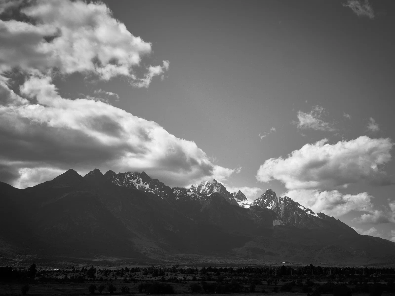 Cloud and mist conceal the outlines of mountains