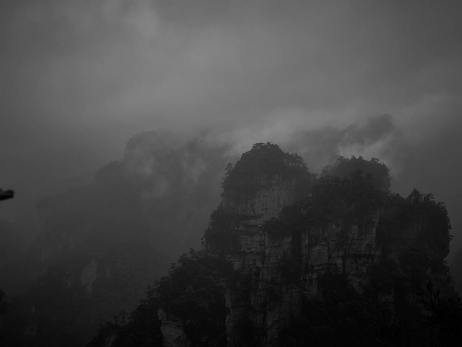 Cloud and mist conceal the outlines of mountains