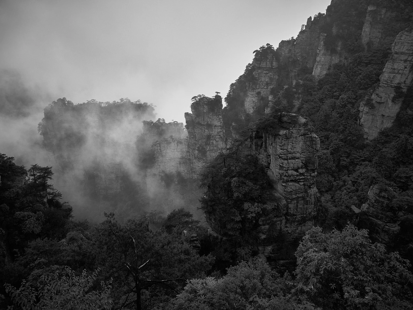 Cloud and mist conceal the outlines of mountains