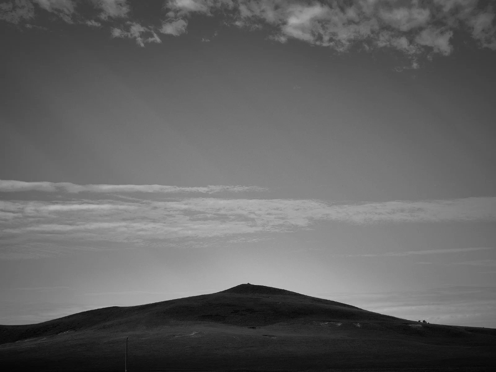 A low hill beneath an open sky