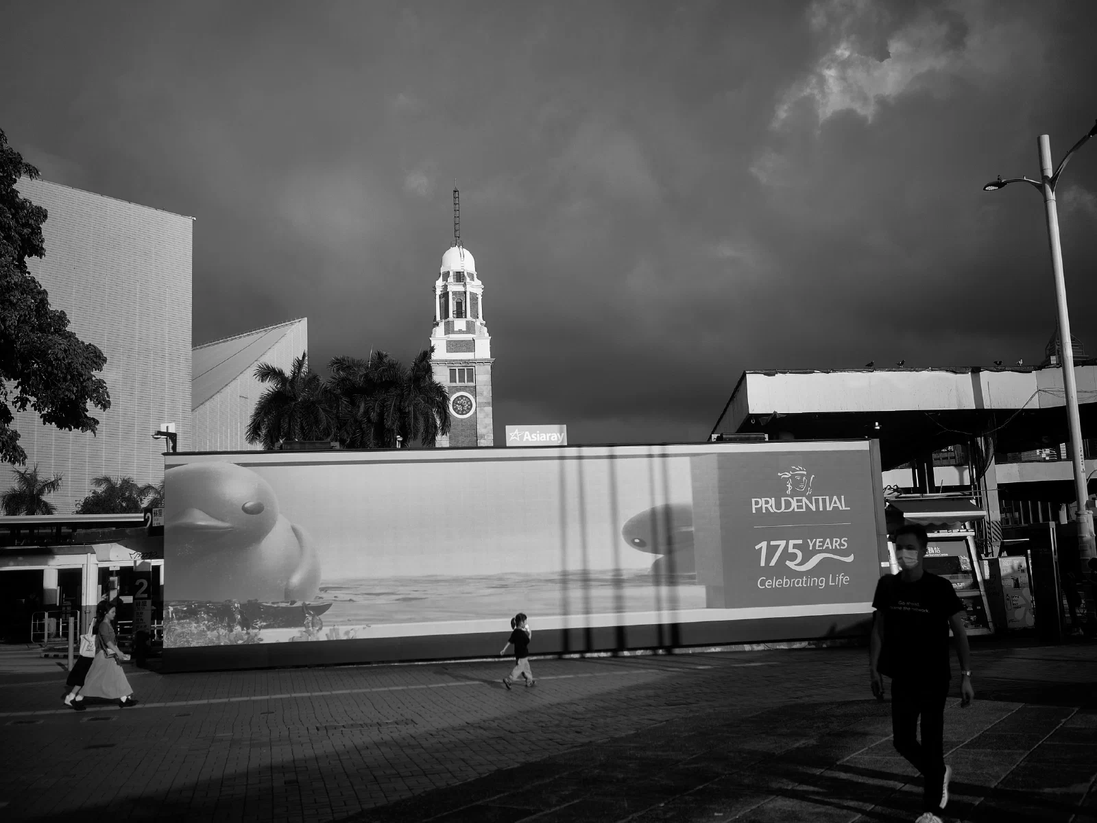 Buildings with figures or vessels in an open space