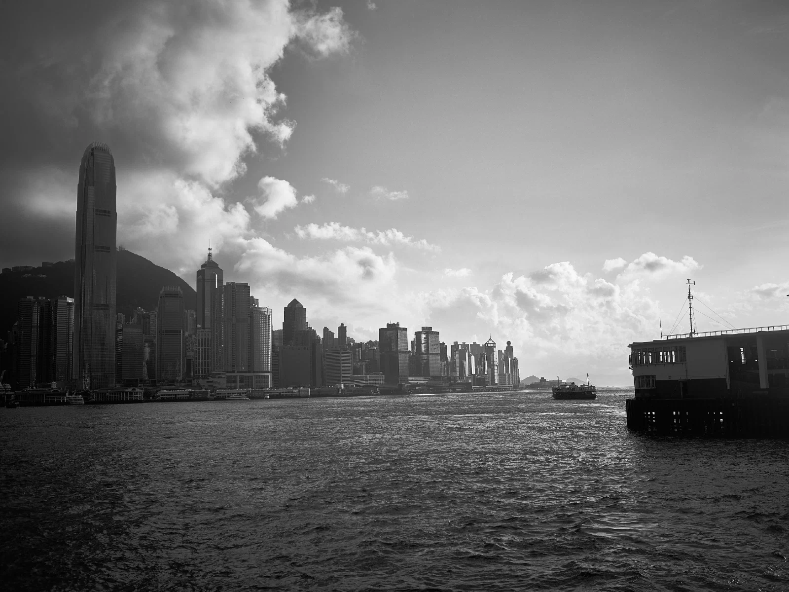 Buildings with figures or vessels in an open space