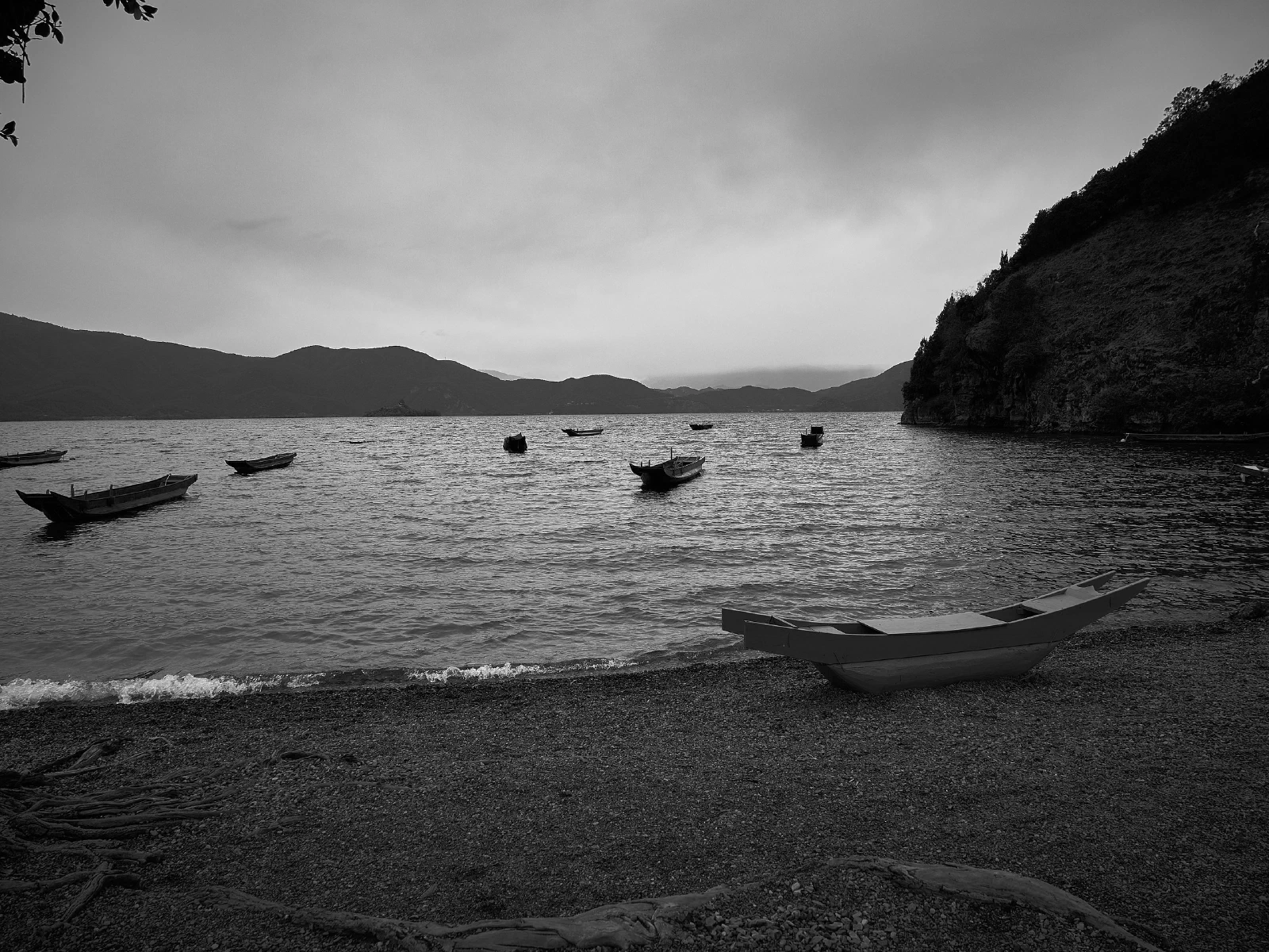 Water, a distant shore and boats at rest