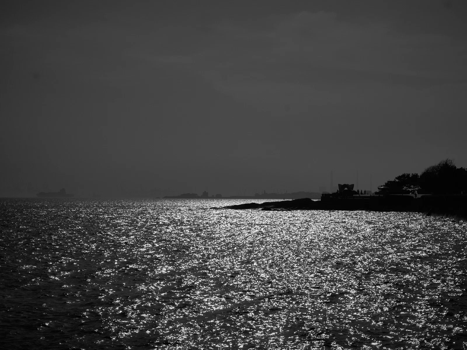 Water, a distant shore and boats at rest